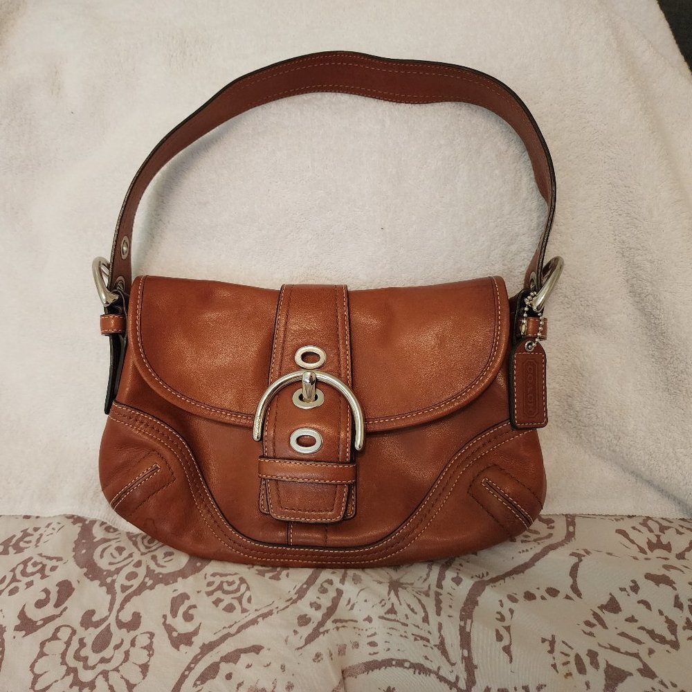 Stylish Coach brown leather purse with front pocket and silver metal clasps